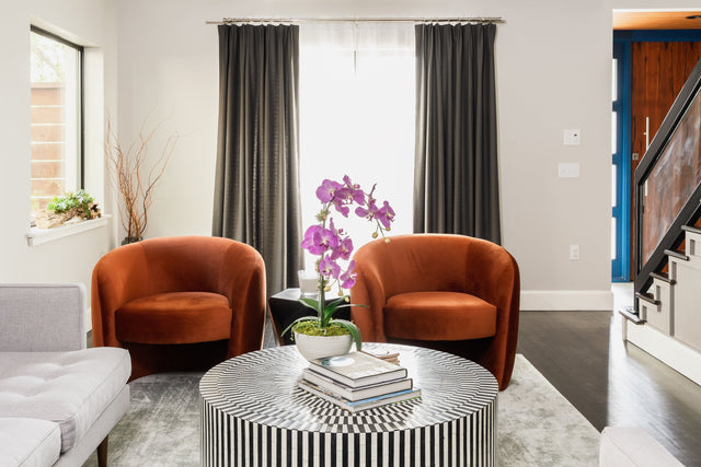 mid-century modern living room featuring clean lines, a walnut coffee table, statement lighting, and retro-inspired décor elements.